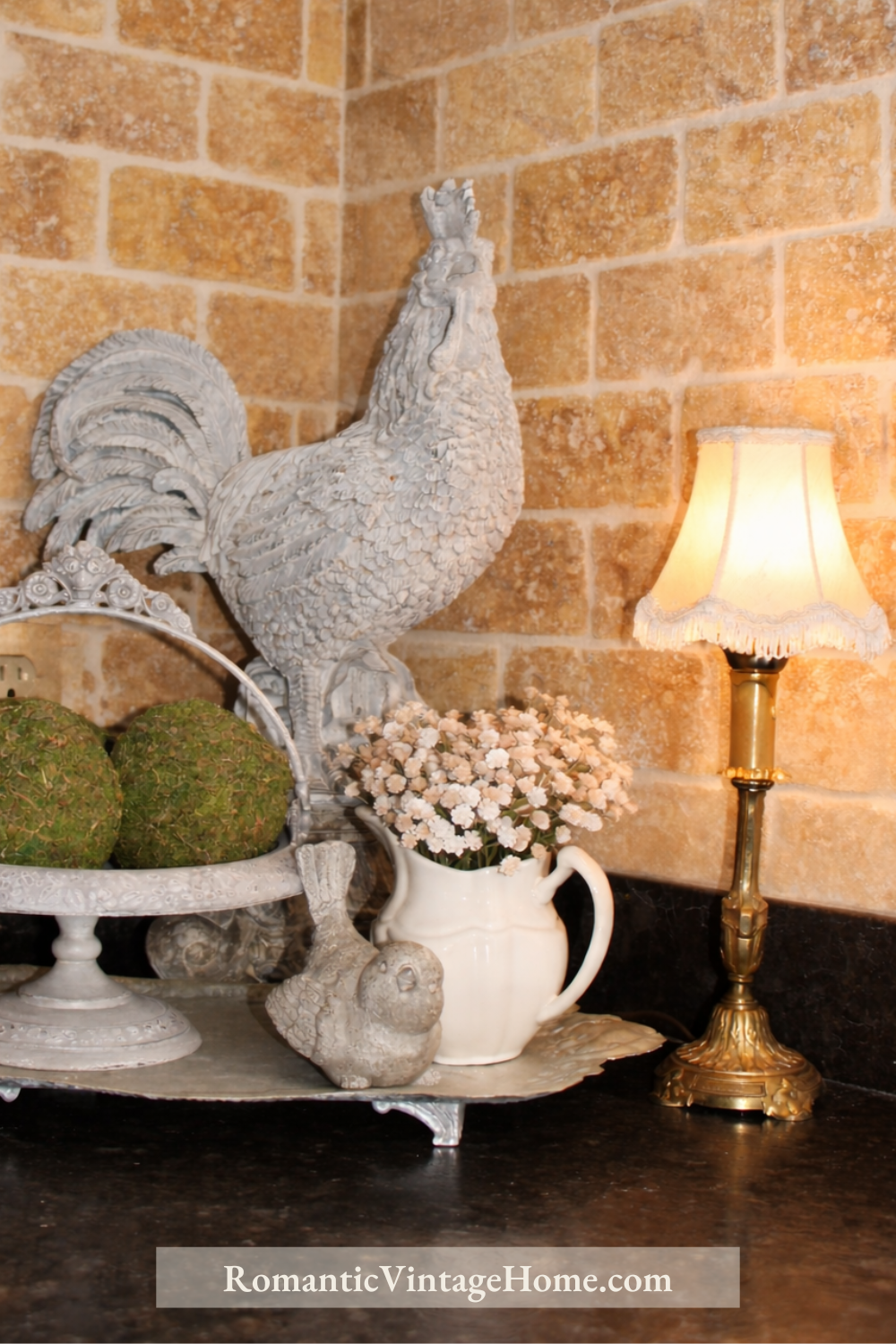 Vintage kitchen nook with a small French lamp casting a soft warm glow beside collected decor